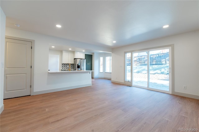 unfurnished living room with light hardwood / wood-style flooring