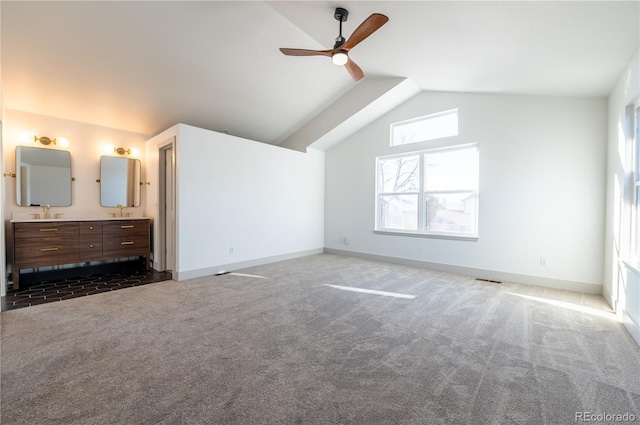 additional living space with ceiling fan, dark carpet, and lofted ceiling