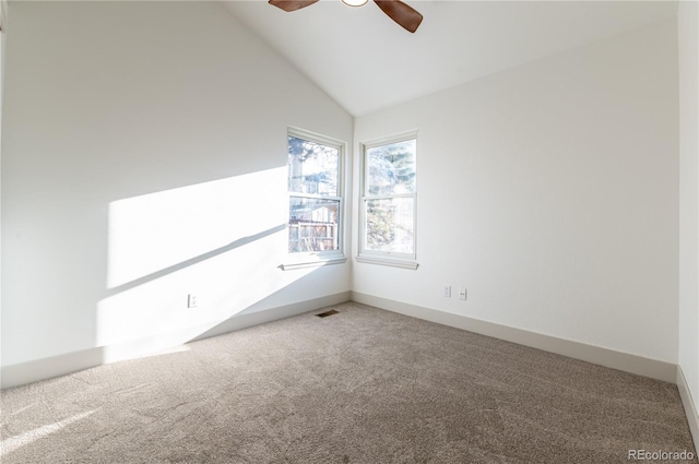 carpeted empty room with ceiling fan and lofted ceiling