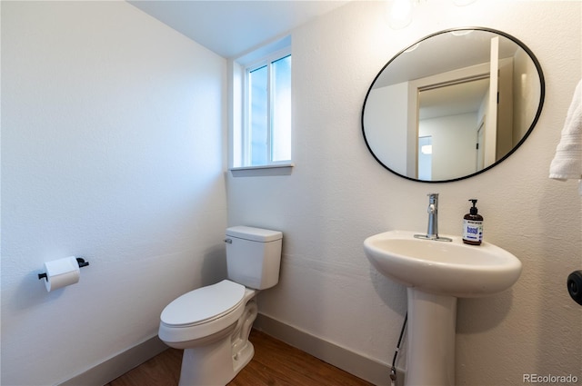 bathroom featuring hardwood / wood-style floors, toilet, and lofted ceiling