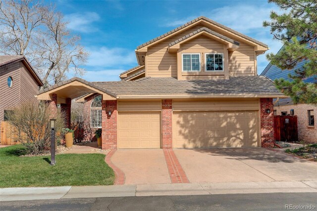 8101 E Dartmouth Ave Unit 22, Denver, CO 80231 - traditional-style house with brick siding, a garage, driveway, a tile roof, and a front lawn