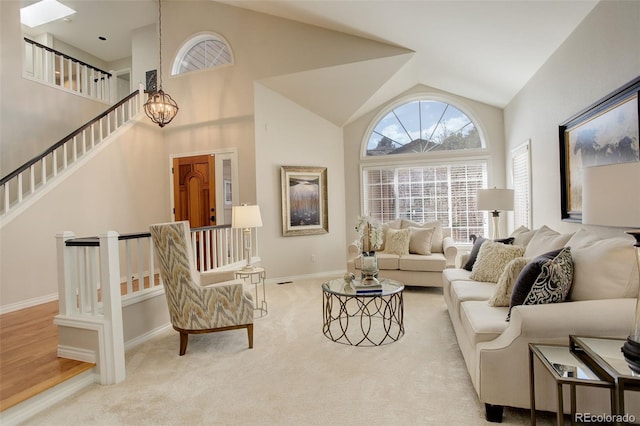 8101 E Dartmouth Ave Unit 22, Denver, CO 80231 - living room with carpet flooring, baseboards, stairs, high vaulted ceiling, and a chandelier