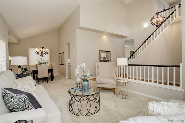 8101 E Dartmouth Ave Unit 22, Denver, CO 80231 - living area with a chandelier, carpet floors, stairs, baseboards, and high vaulted ceiling