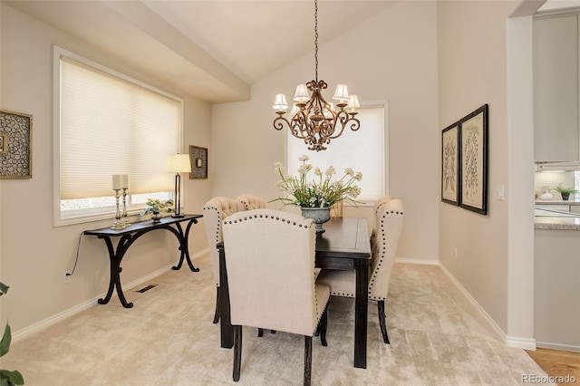 8101 E Dartmouth Ave Unit 22, Denver, CO 80231 - dining area featuring a chandelier, light colored carpet, baseboards, and vaulted ceiling
