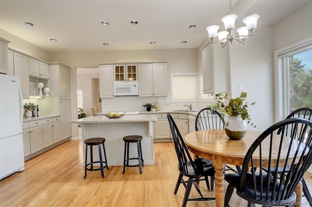 8101 E Dartmouth Ave Unit 22, Denver, CO 80231 - dining room with light wood-type flooring, a chandelier, and recessed lighting