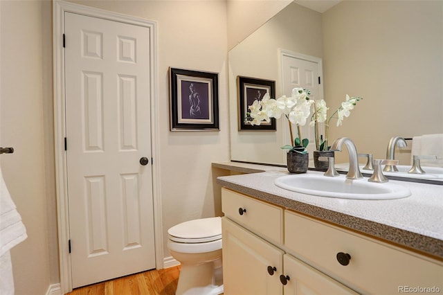 8101 E Dartmouth Ave Unit 22, Denver, CO 80231 - bathroom with vanity, toilet, and wood finished floors