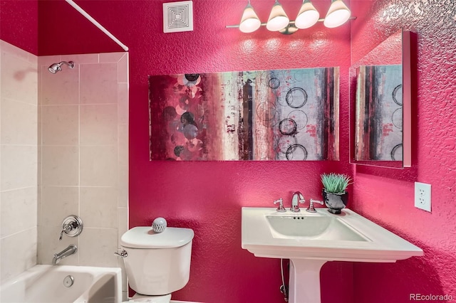 full bathroom with toilet, tiled shower / bath, and sink