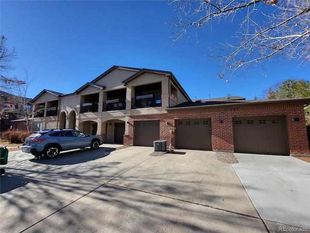 view of front of home featuring a garage and central AC