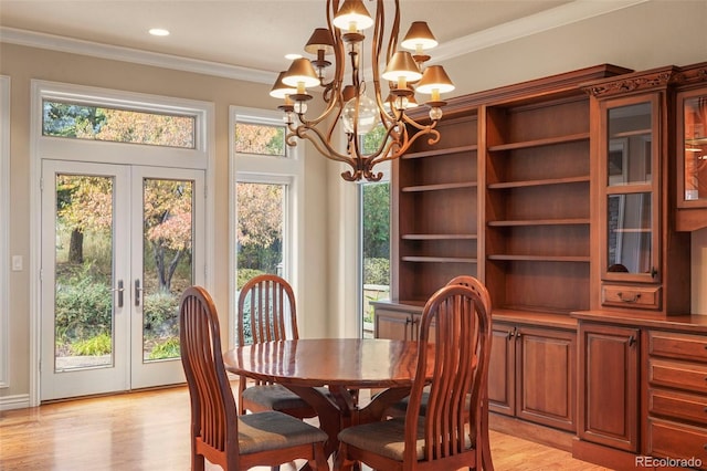 dining area with ornamental molding, plenty of natural light, french doors, and light hardwood / wood-style floors