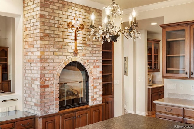 kitchen featuring pendant lighting, ornamental molding, and a chandelier