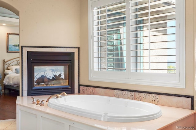 bathroom featuring a washtub and tile patterned floors