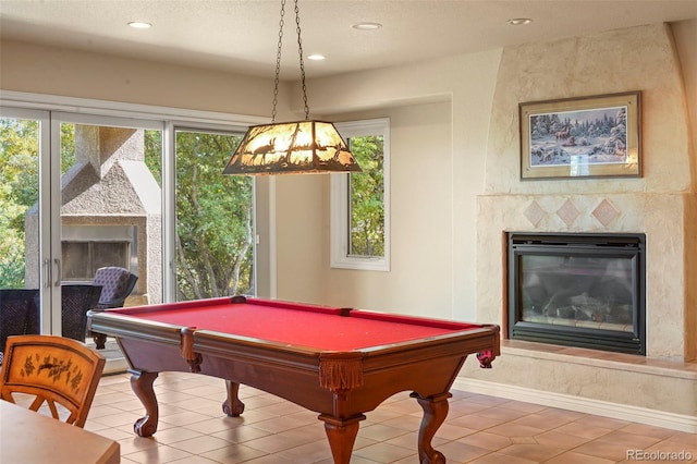 rec room with a tiled fireplace, tile patterned flooring, and billiards