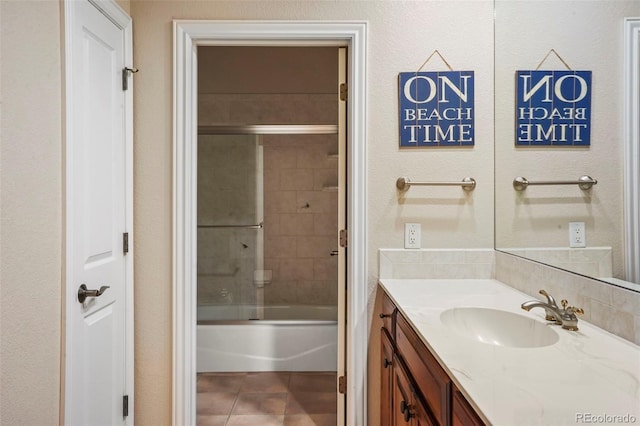 bathroom with enclosed tub / shower combo, vanity, and tile patterned floors