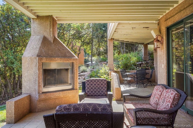 view of patio with exterior fireplace