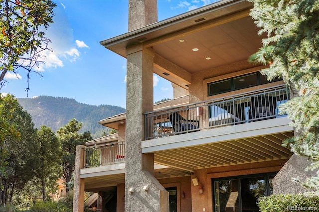 exterior space with a mountain view and a balcony