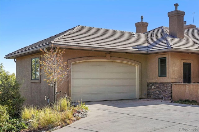 view of side of home featuring a garage