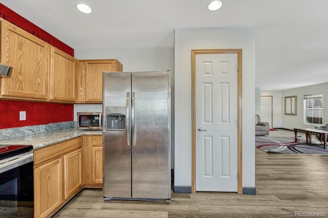 kitchen featuring light hardwood / wood-style floors and appliances with stainless steel finishes