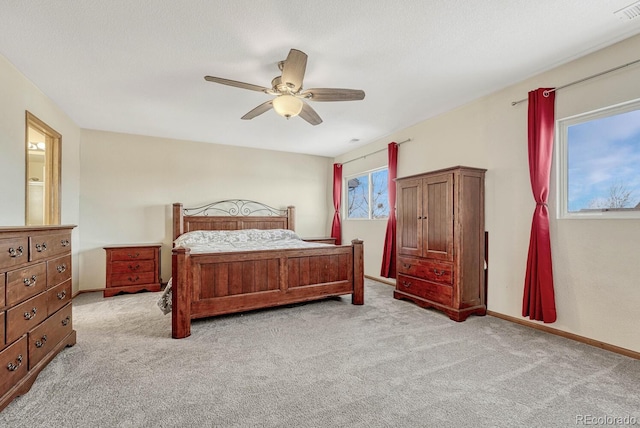 bedroom with ceiling fan and light colored carpet