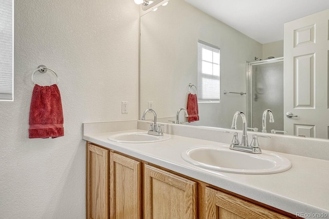 bathroom with an enclosed shower and vanity