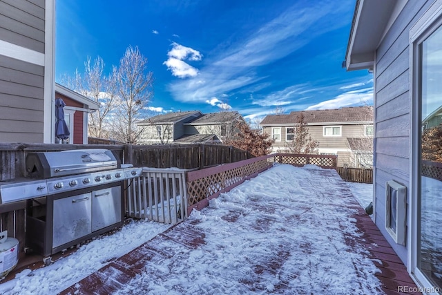 yard covered in snow with a wooden deck