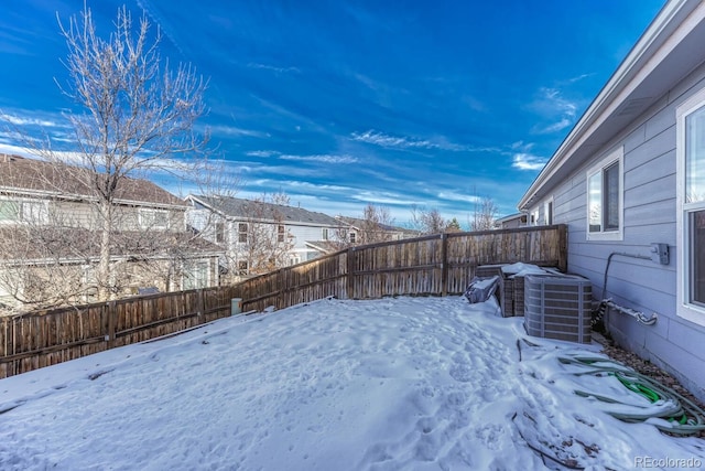 yard layered in snow with cooling unit