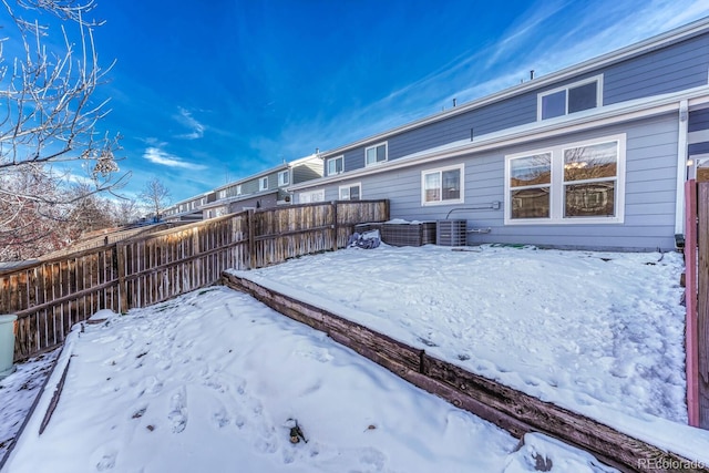 yard covered in snow featuring cooling unit