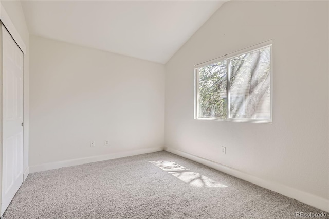 unfurnished bedroom with a closet, carpet, and vaulted ceiling