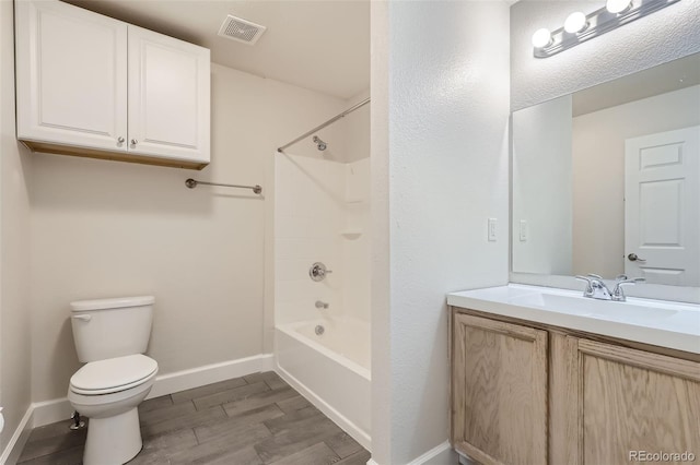 full bathroom featuring shower / bath combination, toilet, hardwood / wood-style flooring, and vanity