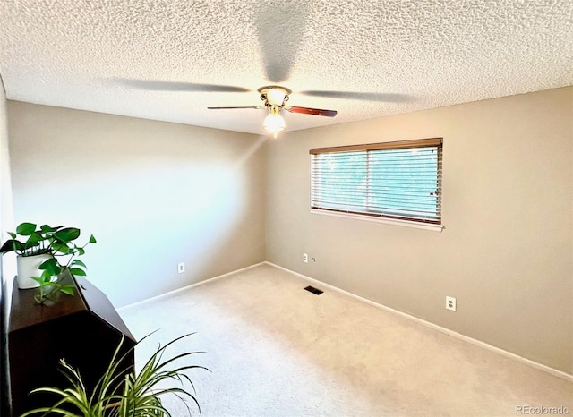 unfurnished room featuring ceiling fan, a textured ceiling, and carpet flooring