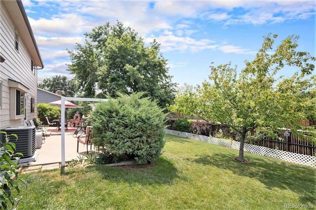 view of yard featuring central AC unit and a patio