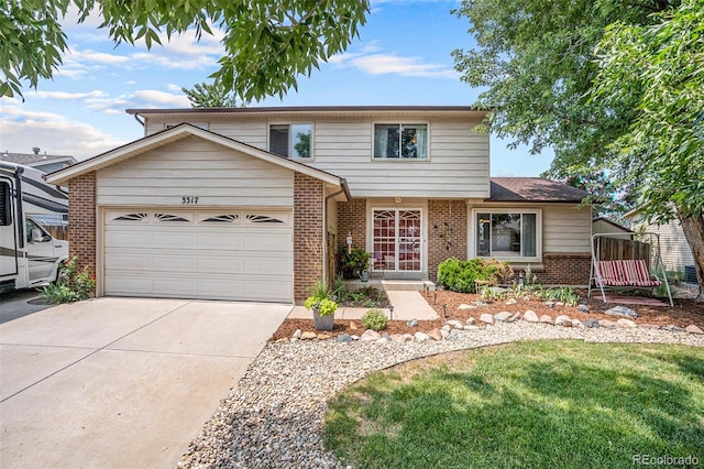 view of property featuring a garage and a front lawn