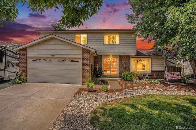 view of property with a garage and a yard