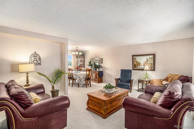 carpeted living room with a textured ceiling and a notable chandelier