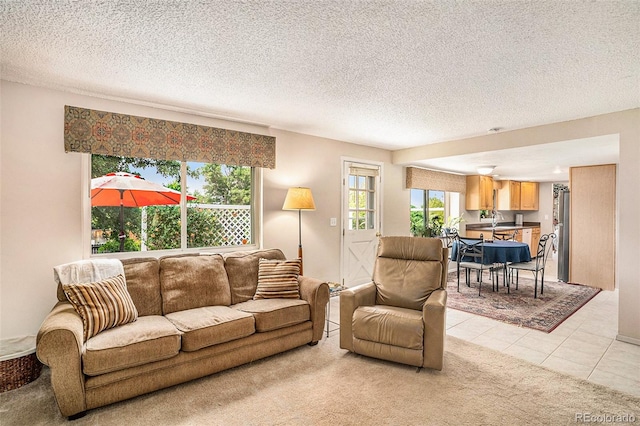 tiled living room featuring a textured ceiling and sink