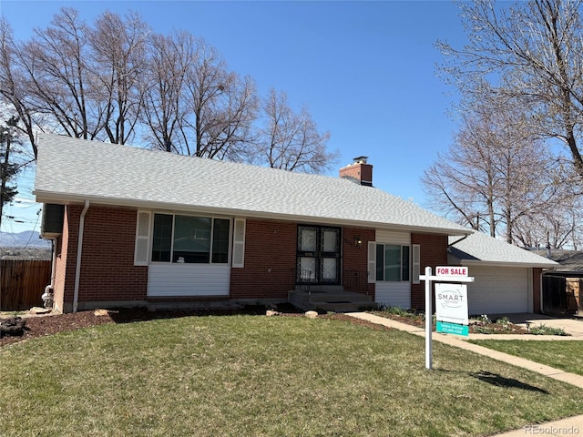 ranch-style home with a front yard, a garage, a chimney, fence, and brick siding