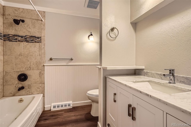 bathroom featuring visible vents, toilet, wainscoting, and wood finished floors