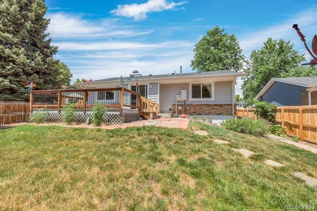 17634 E Eldorado Pl, Aurora, CO 80013 - back of house featuring a fenced backyard, brick siding, and a wooden deck
