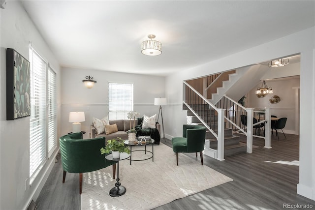 living room with wood-type flooring and a chandelier