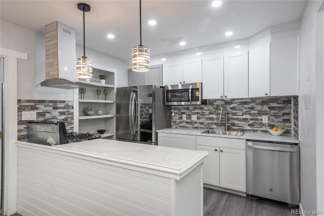 kitchen with pendant lighting, sink, appliances with stainless steel finishes, white cabinetry, and exhaust hood