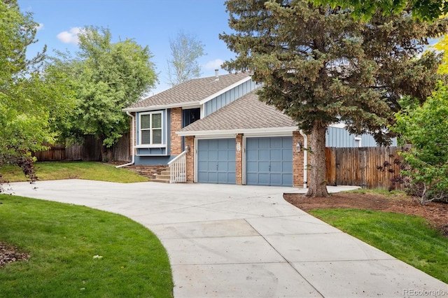 8174 Dudley Cir, Arvada, CO 80005 - split level home with a garage, driveway, and brick siding