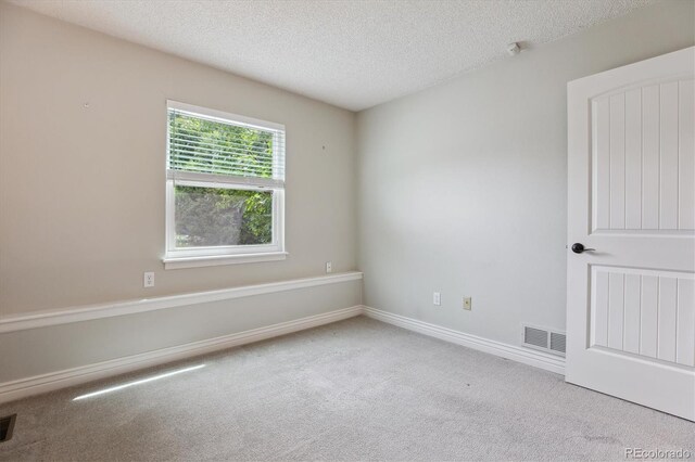 8174 Dudley Cir, Arvada, CO 80005 - spare room featuring carpet flooring, a textured ceiling, and baseboards