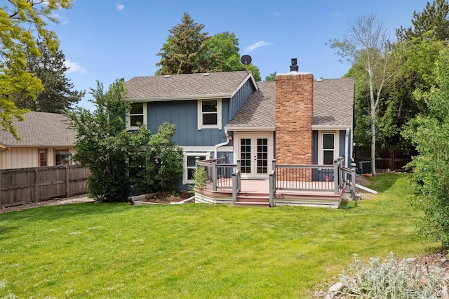 8174 Dudley Cir, Arvada, CO 80005 - back of house with board and batten siding, french doors, a wooden deck, a chimney, and a shingled roof