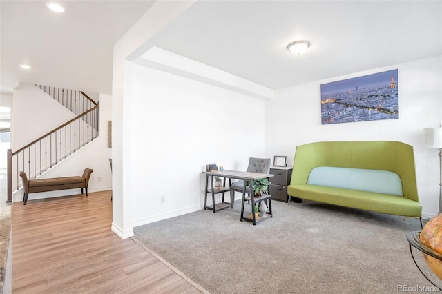 sitting room with wood-type flooring