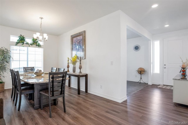 dining room featuring a notable chandelier and dark hardwood / wood-style floors