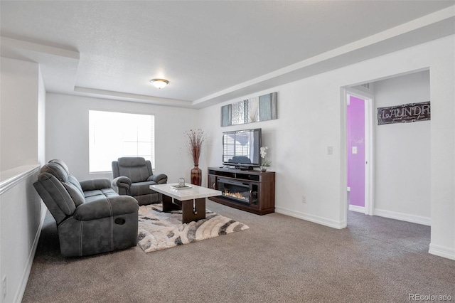 living room featuring light carpet, a healthy amount of sunlight, and a fireplace