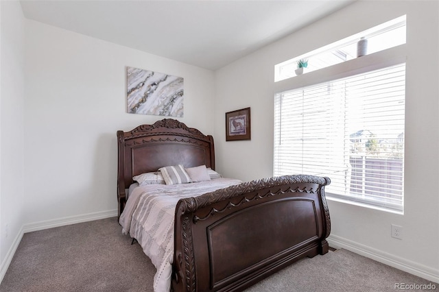 bedroom featuring light carpet and multiple windows