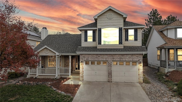 view of front facade featuring covered porch and a garage