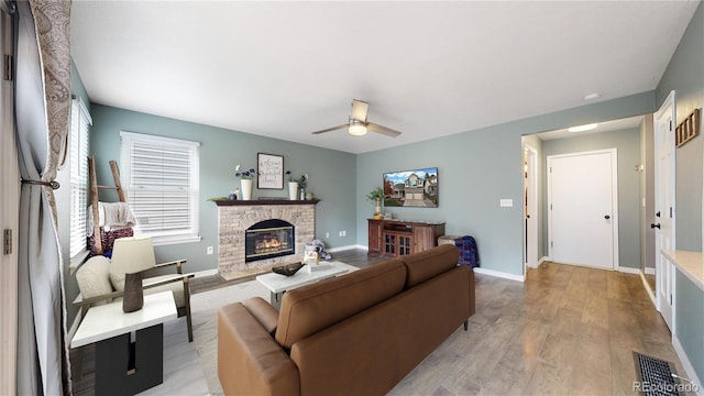 living room with ceiling fan and light hardwood / wood-style floors