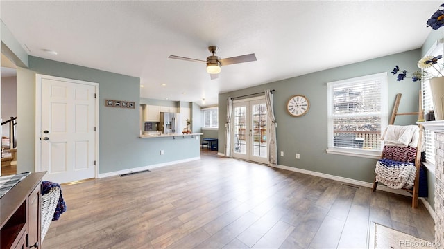 living room with hardwood / wood-style floors and ceiling fan