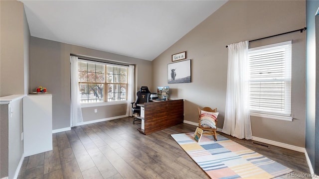 sitting room featuring vaulted ceiling and dark wood-type flooring